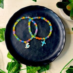 Handmade bead bracelets with a random charm, cross or bunny